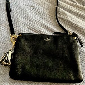 Kate Spade black pebbles leather purse with black and white tassel.